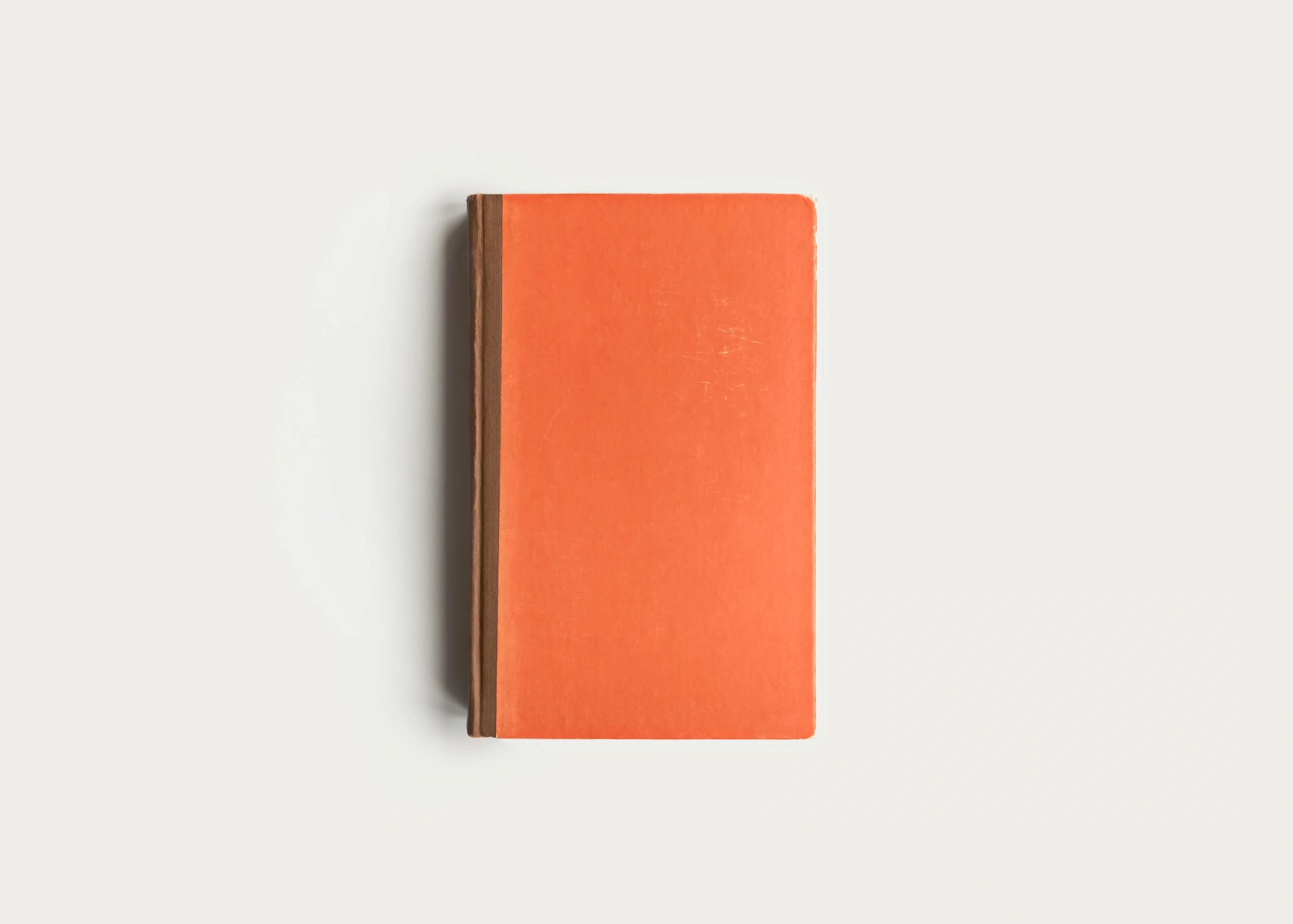 Closed vintage book on a warm neutral background